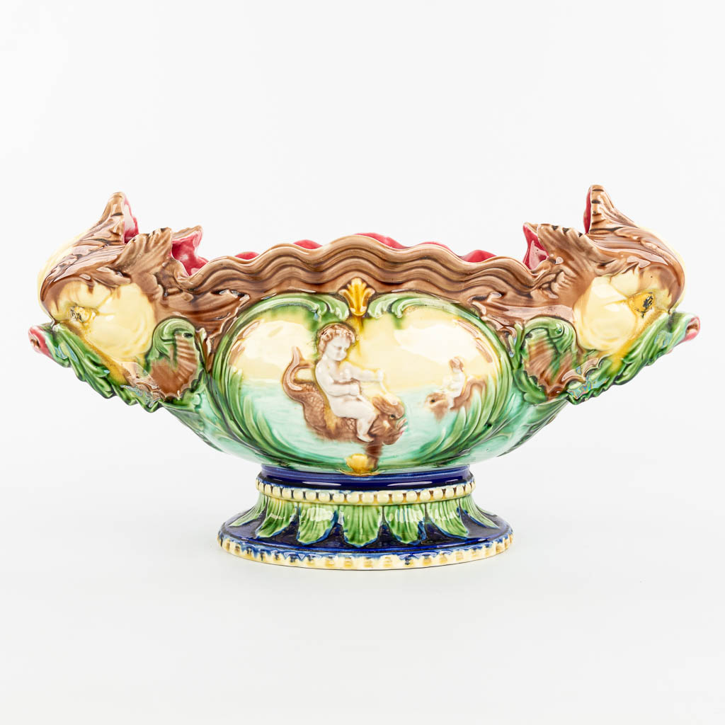A cache-pot flower pot made of glazed faience in art nouveau style and decorated with putti and fish. (H:26cm)