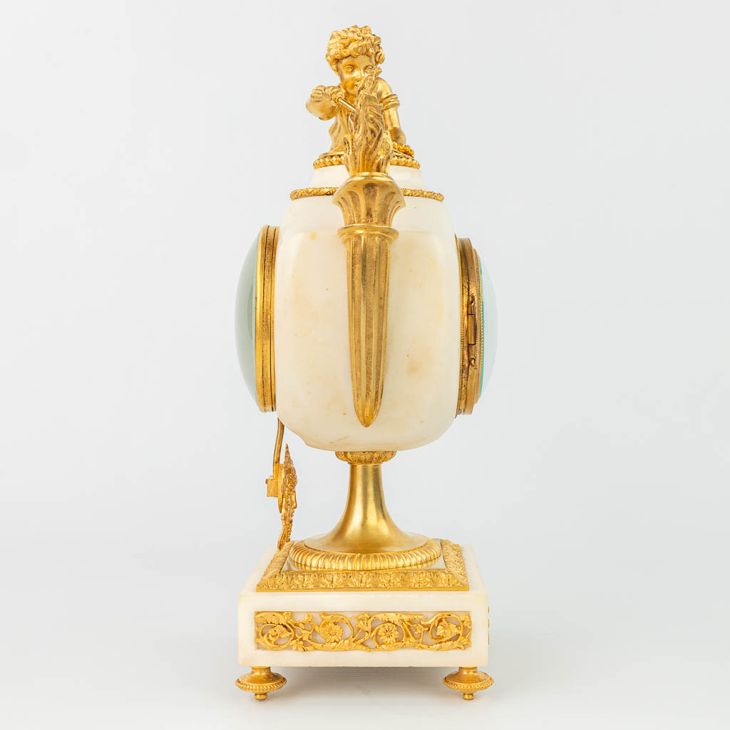A mantle clock made of white Carrara marble mounted with gilt bronze 
