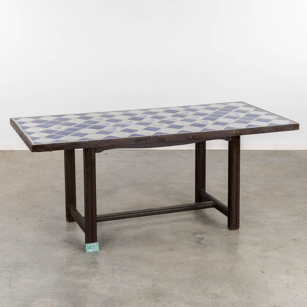 A Spanish table, finished with white and blue tiles. (L:85 x W:184 x H:76 cm)