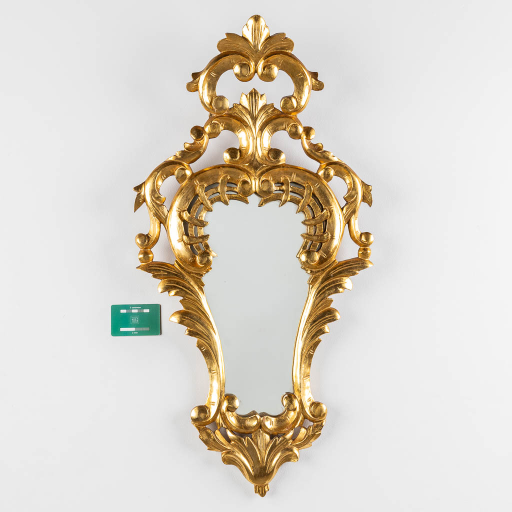 An antique mirror, sculptured and gilt wood, Roccoco style. Circa 1900. (W:42 x H:82 cm)