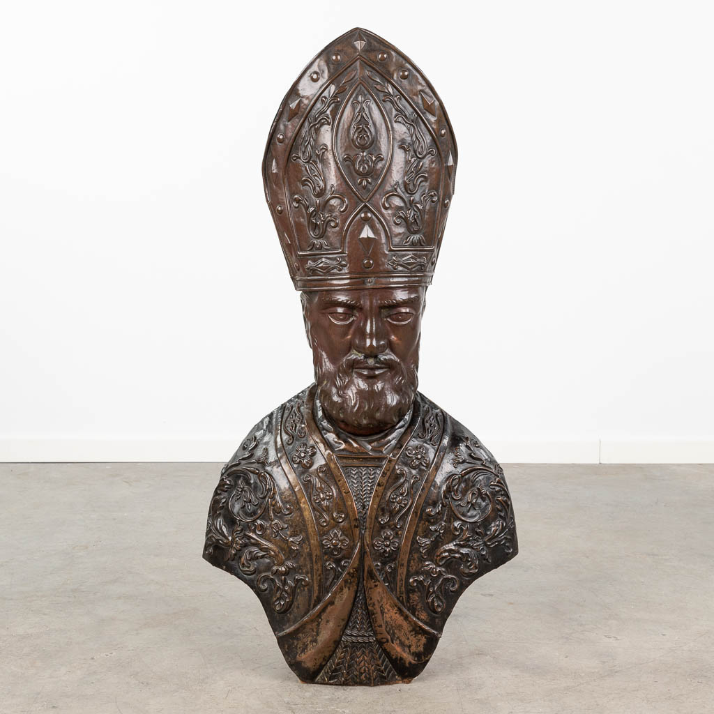 A statue of a Bishop, made of repoussé copper on a wood base. Italy, 19th century.  (L:24 x W:48 x H:91 cm)
