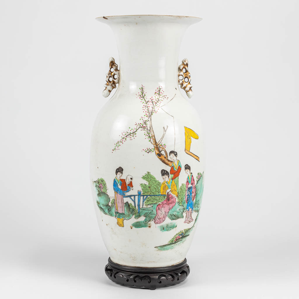 A vase made of Chinese porcelain and decorated with ladies and calligraphy.