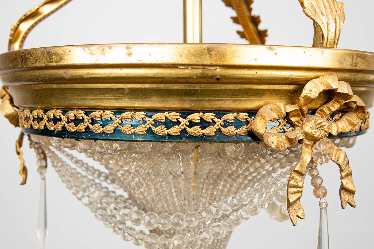 A sac-a-perles chandelier made of bronze and glass in Louis XVI style. 