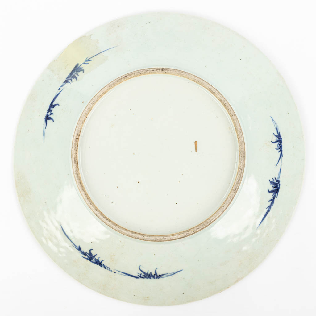 A large Chinese plate with blue-white floral decor. 